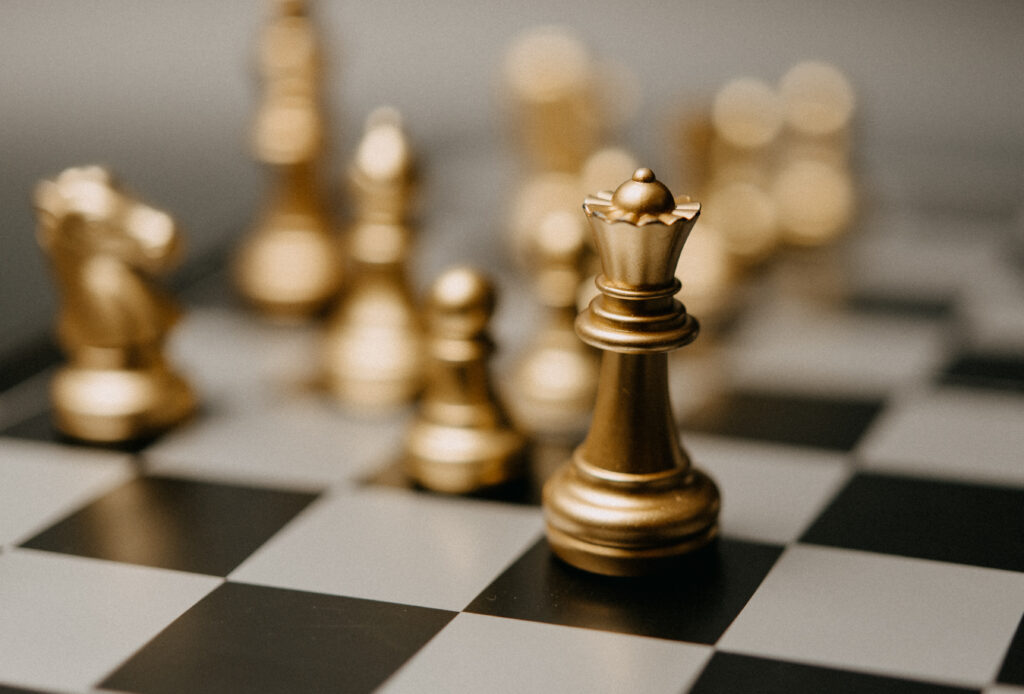 Golden King chess standing in front on board game Concept leadership strategy business